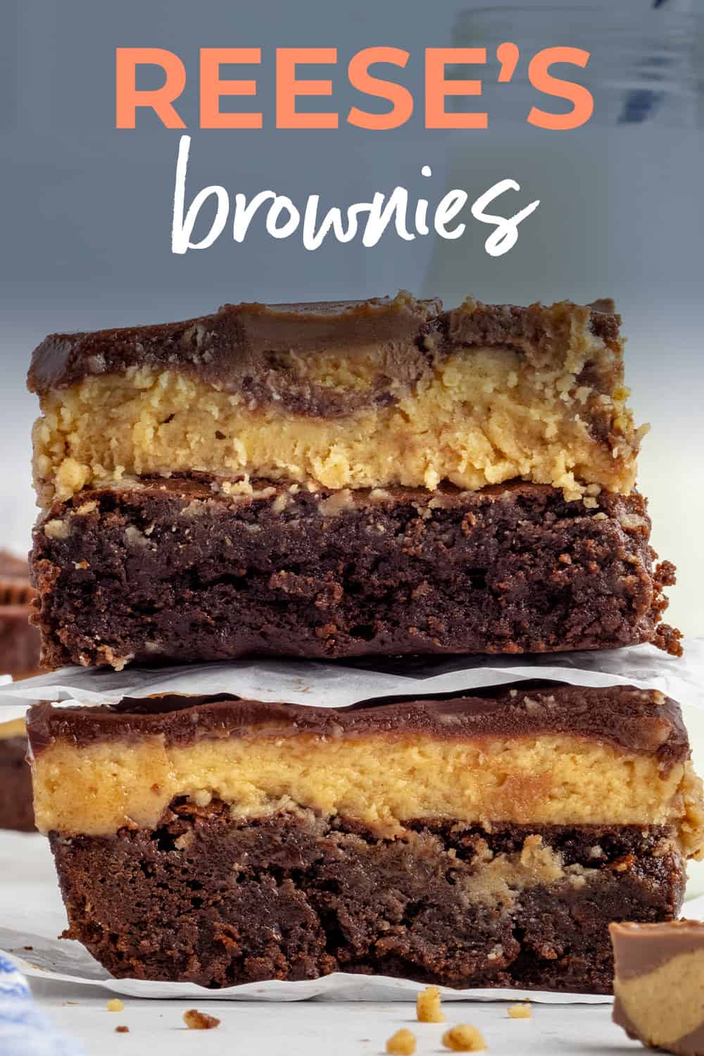 Stack of brownies topped width peanut butter and chocolate.