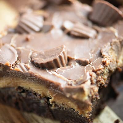 These thick, fudgy brownies are topped with a thick peanut butter frosting, extra chocolate, and some Reese's candies. They're a peanut butter lovers favorite brownie!