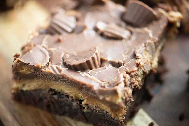 These thick, fudgy brownies are topped with a thick peanut butter frosting, extra chocolate, and some Reese's candies. They're a peanut butter lovers favorite brownie!