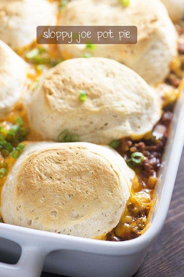 Sloppy joe topped with biscuits in a white baking dish.