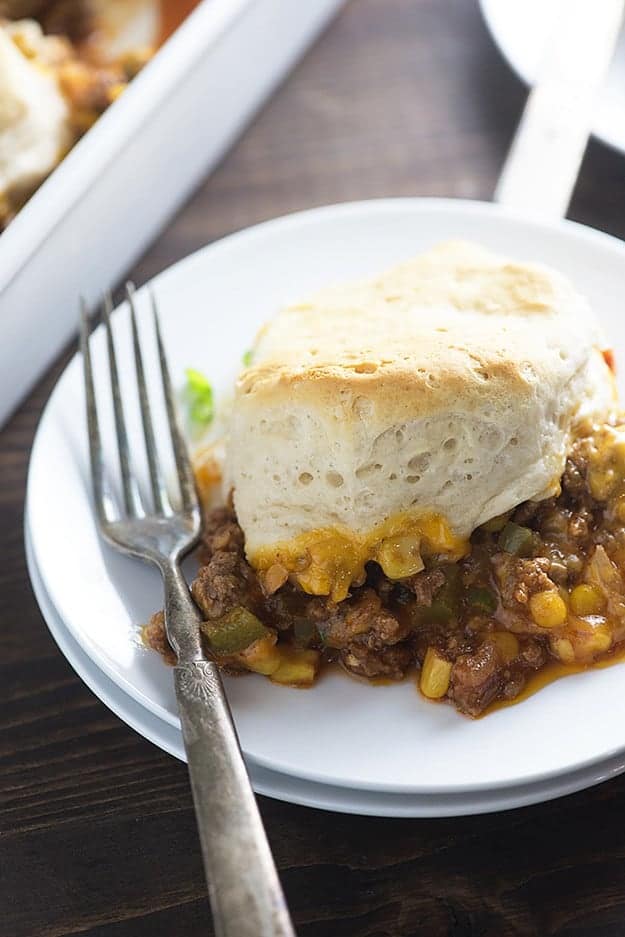 A plate of sloppy joe pot pie with a silver fork.