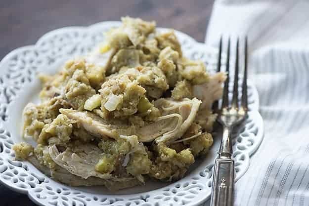 This crock pot chicken and stuffing is total comfort food! The chicken is tender and the stuffing mix cooks right in the slow cooker with the chicken! 