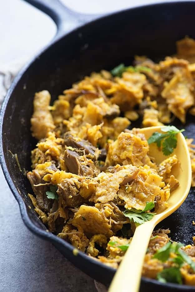 A cast-iron skillet of carnitas chilaquiles.