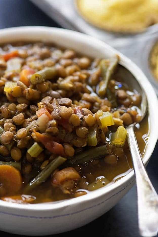 This lentil soup recipe is loaded with fresh veggies and makes a really hearty and healthy dinner! lentil soup in white bowl