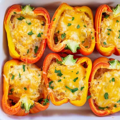 chicken stuffed peppers in white dish.