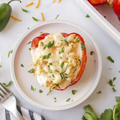 Cream cheese stuffed pepper on white plate.