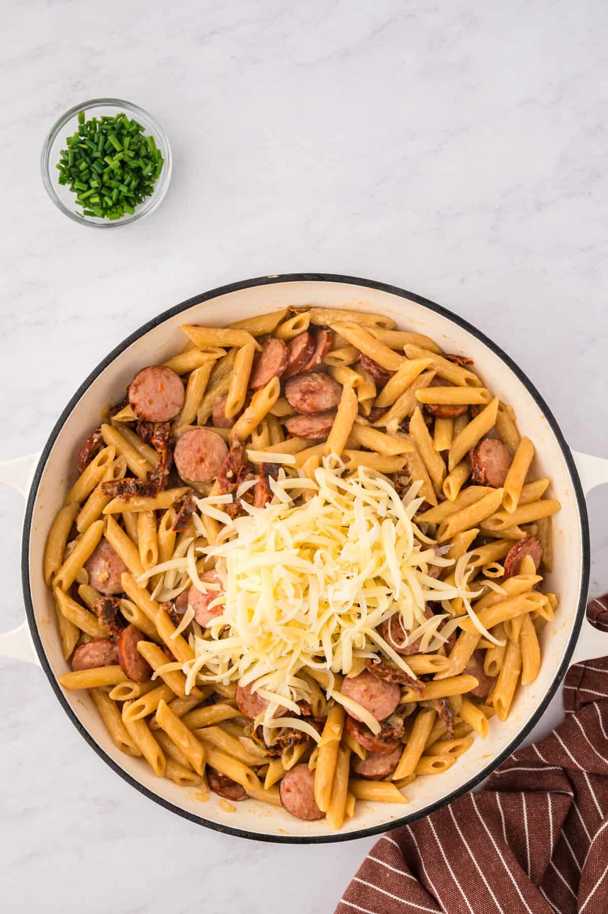 Gruyere cheese piled over pasta.
