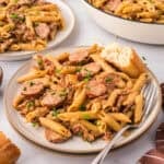 Small white plate topped with smoked sausage pasta recipe.