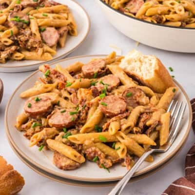 Small white plate topped with smoked sausage pasta recipe.