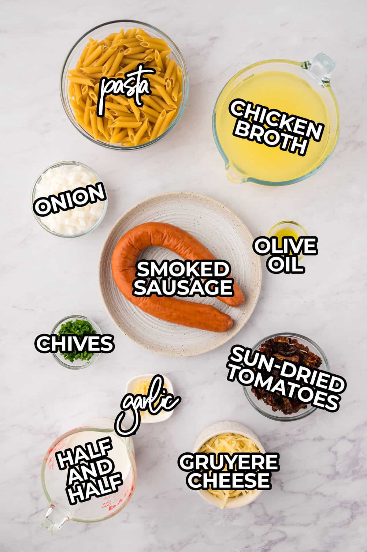 Ingredients for smoked sausage pasta laid out on counter.