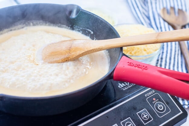 Alfredo sauce in cast iron skillet.