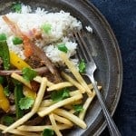 A plate of various vegetables, french fries, and rice.