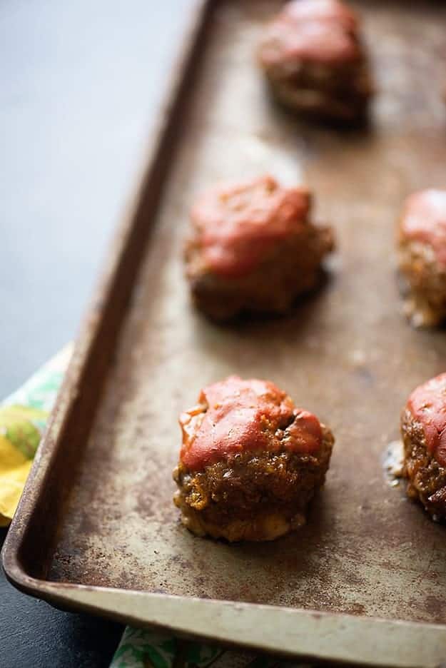 A few meatloaf meatballs on a baking sheet.