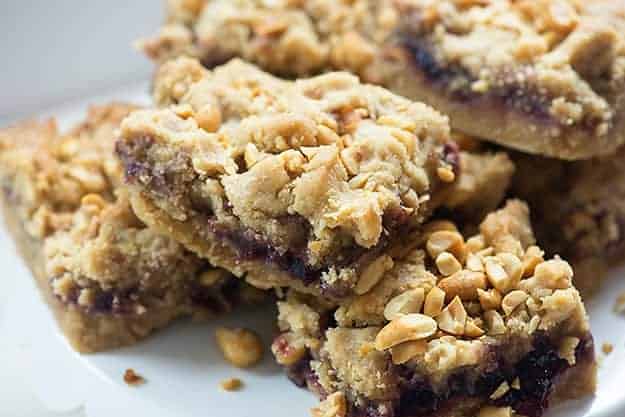 A bunch of stacked up peanut butter and jelly cookie bars.