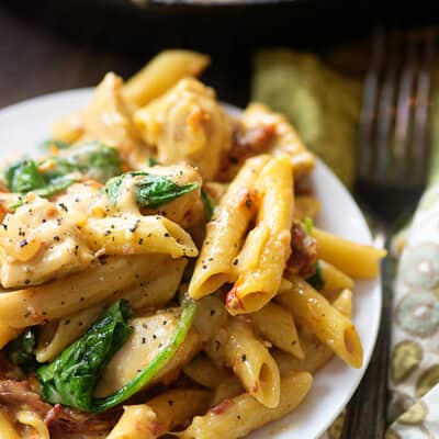 This chicken florentine pasta is made in one skillet and ready in 25 minutes. It's full of chicken, sun-dried tomatoes, and spinach!