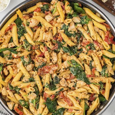 This chicken florentine pasta is made in one skillet and ready in 25 minutes. It's full of chicken, sun-dried tomatoes, and spinach!