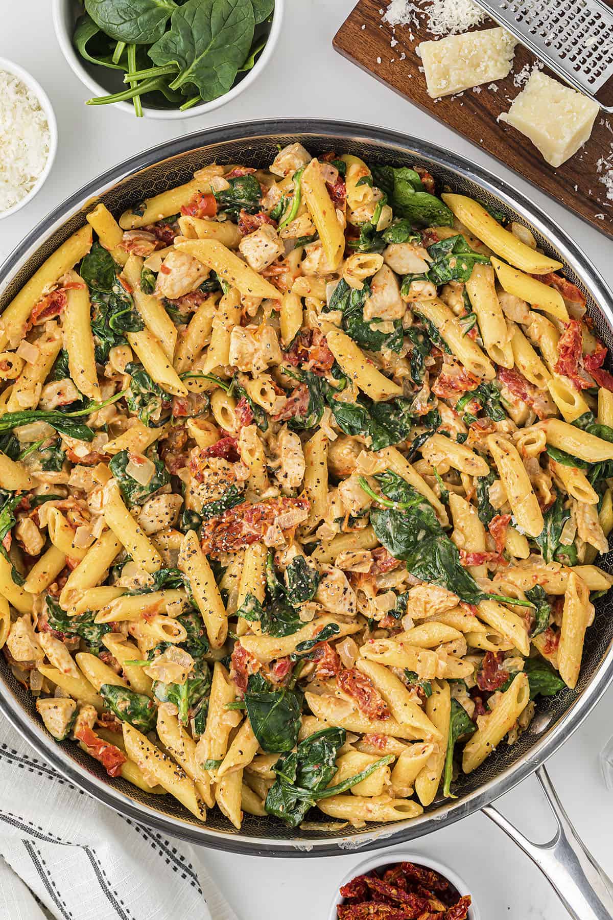 This chicken florentine pasta is made in one skillet and ready in 25 minutes. It's full of chicken, sun-dried tomatoes, and spinach!