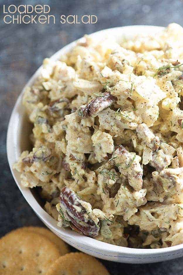 A bowl of chicken salad in a large white bowl.