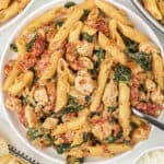 Chicken florentine pasta on white plate.