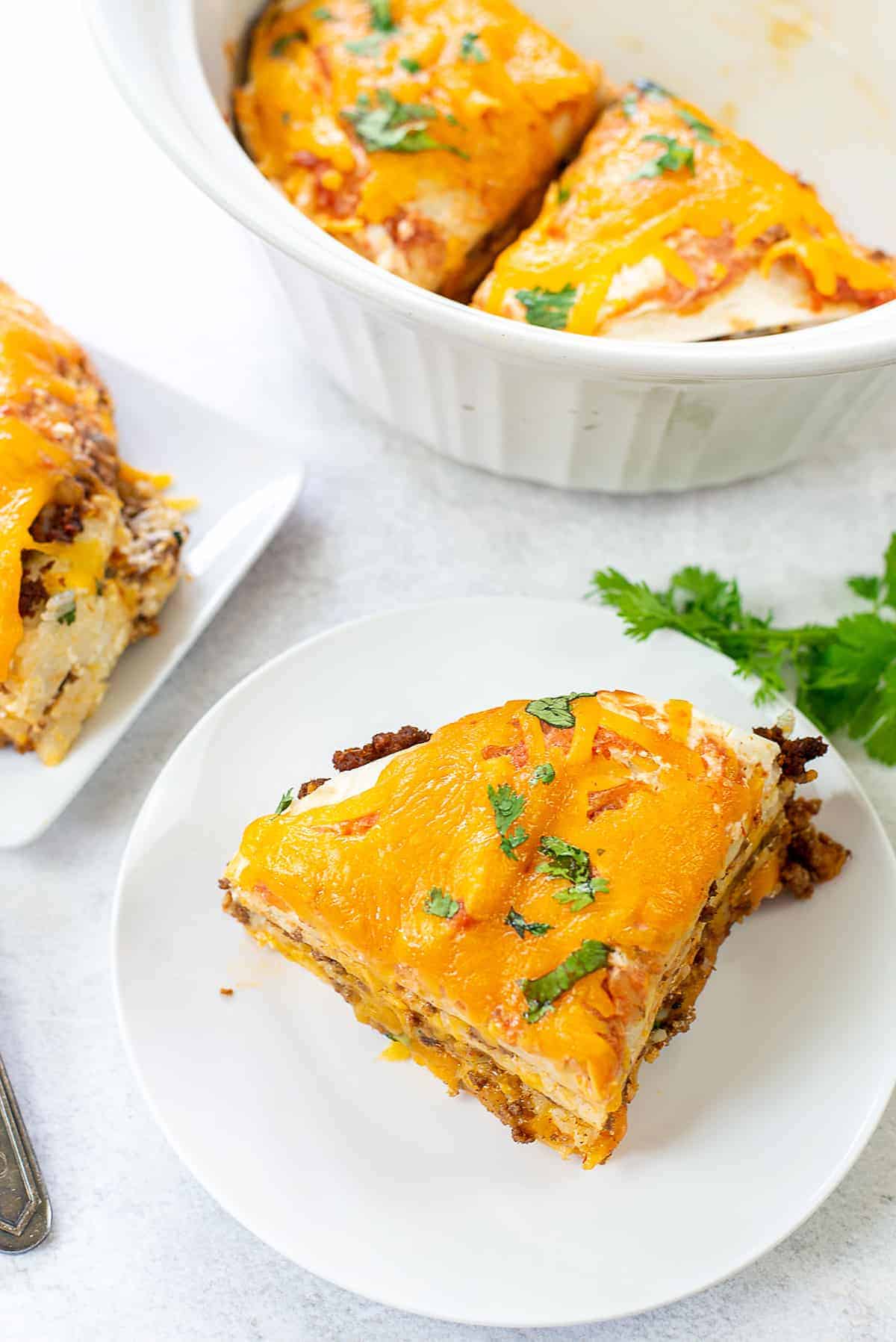 overhead view of burrito casserole on white plates.