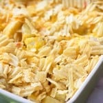 A close up of cheesy potatoes in a baking pan.