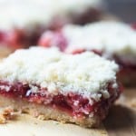A close up of a piece of cherry pie bars.