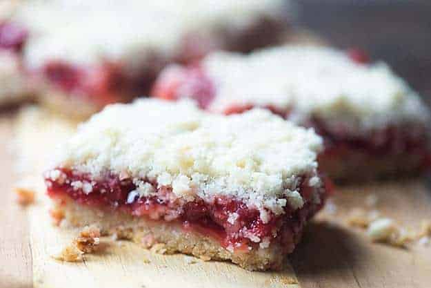 A close up of a piece of cherry pie bars.