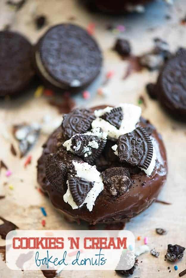Chocolate donut topped with oreo pieces.