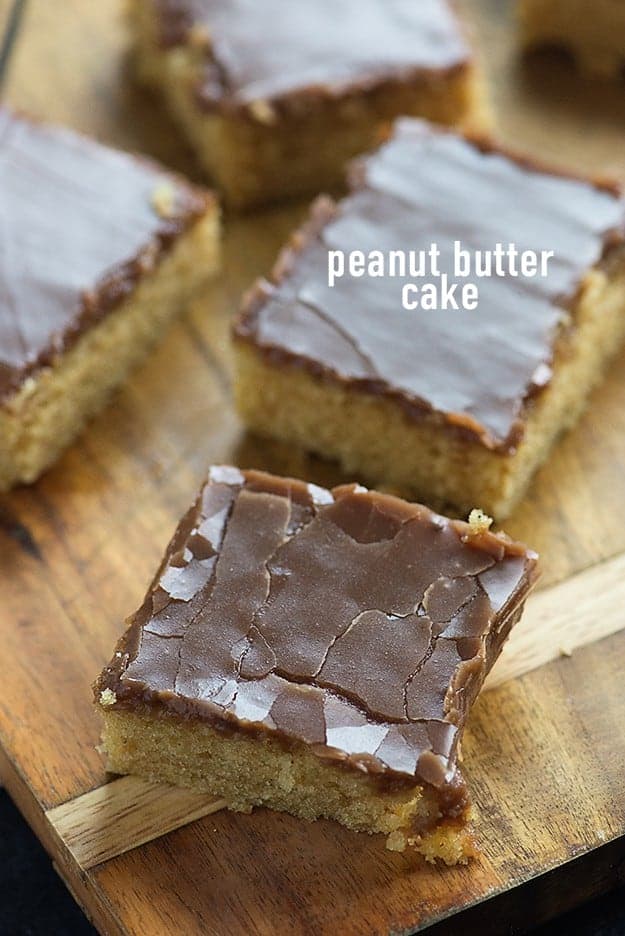 Three peanut butter cake squares on a cutting board.