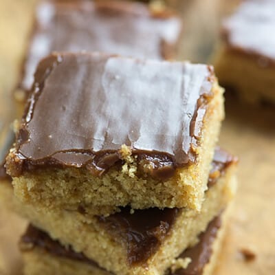 STacked up squares of peanut butter cakes.