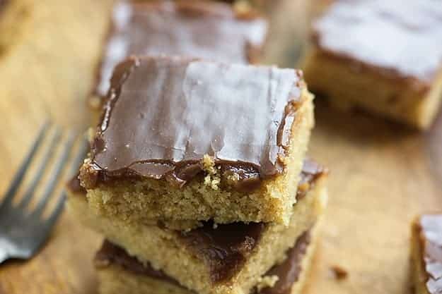 STacked up squares of peanut butter cakes.