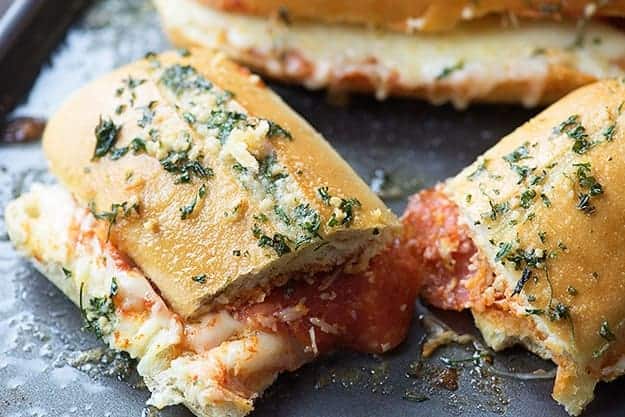 A close up of a sliced pizza bread sandwich.