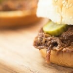 A close up of a sandwich sitting on top of a wooden table