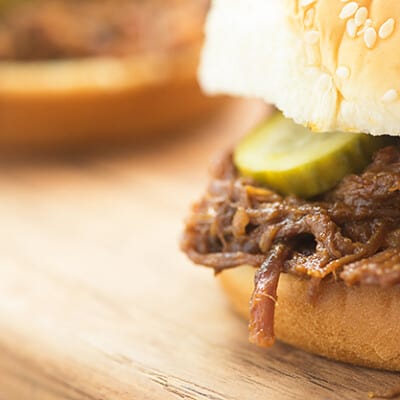 A close up of a sandwich sitting on top of a wooden table