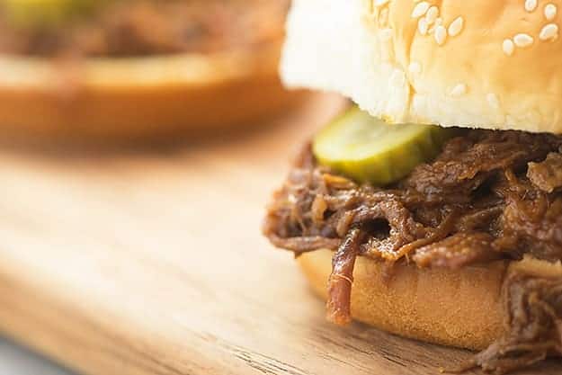 A close up of a sandwich sitting on top of a wooden table