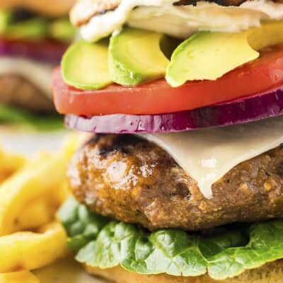 Thick turkey burger on bun with toppings.