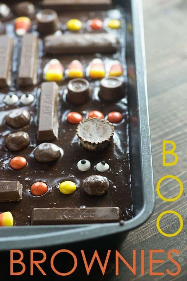 A baking sheet of brownie batter with several candies placed on top.