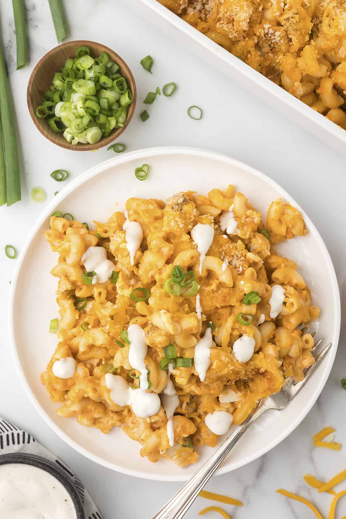 Overhead view of buffalo chicken mac and cheese on white plate.