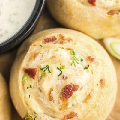 Cream cheese pinwheel next to bowl of ranch dip.