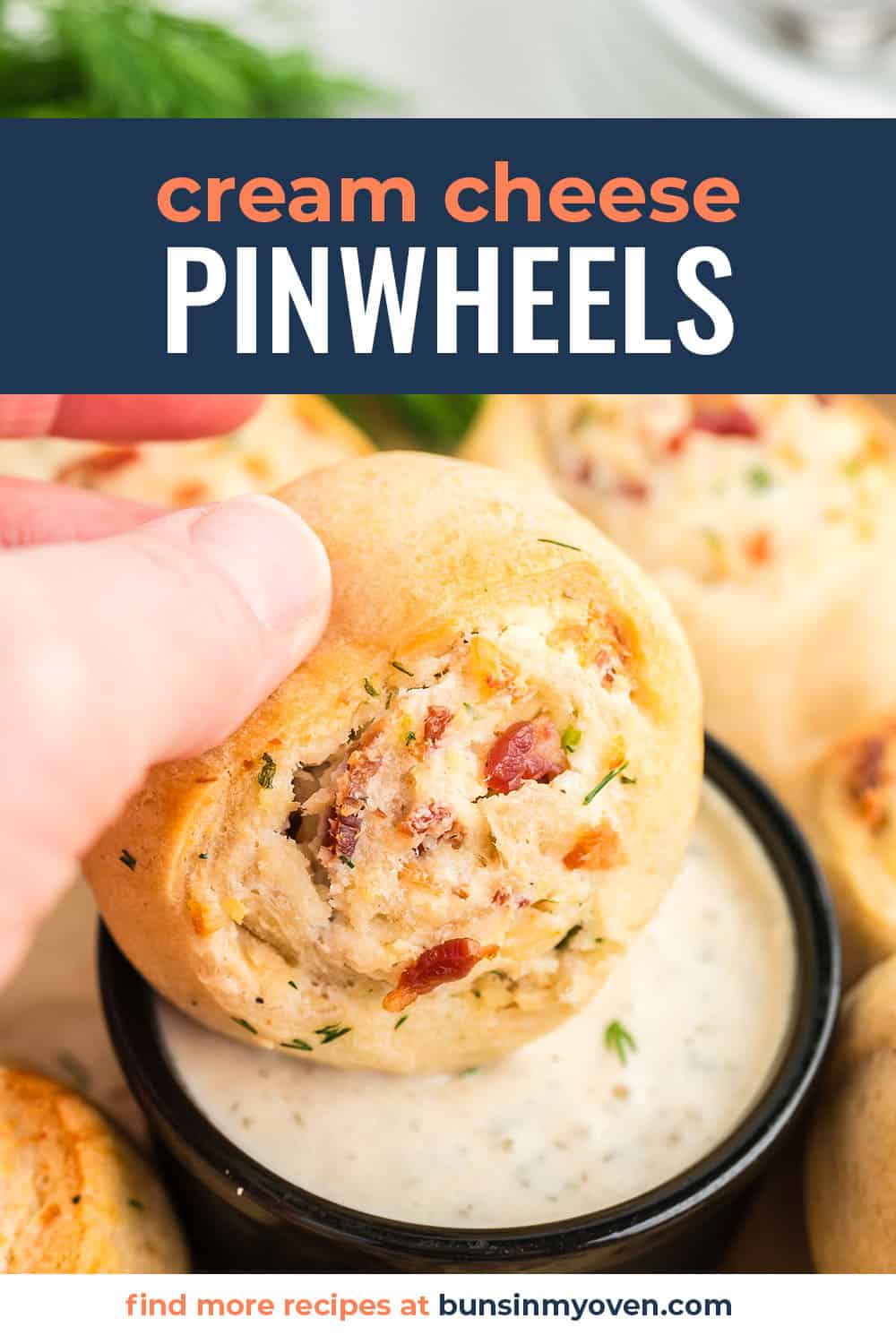 Cream cheese pinwheel being dunked in ranch.