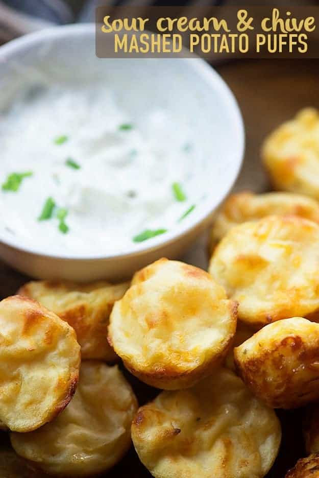 Small piece of potatoes next to a dish of dressing.