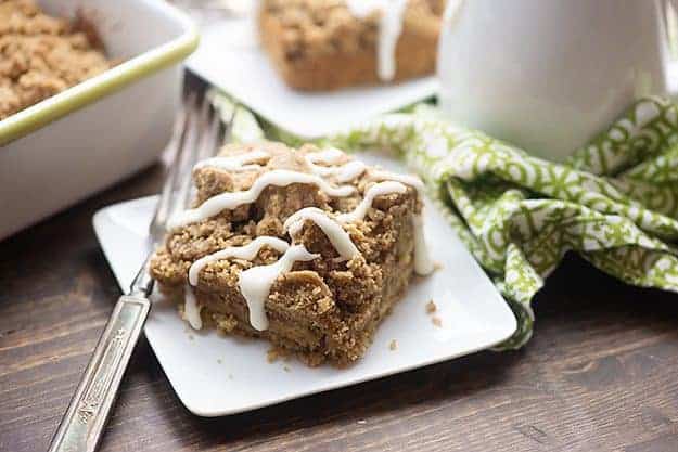 A piece of coffee cake on a square plate.