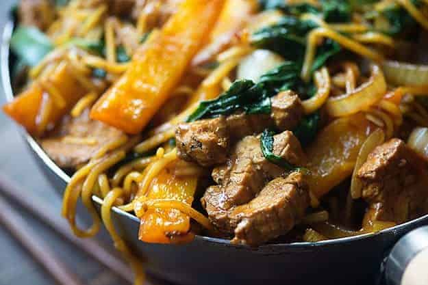 This easy lo mein recipe is full of pork, bell peppers, onions, and spinach. It's ready in less than 30 minutes and even tastier than take out!