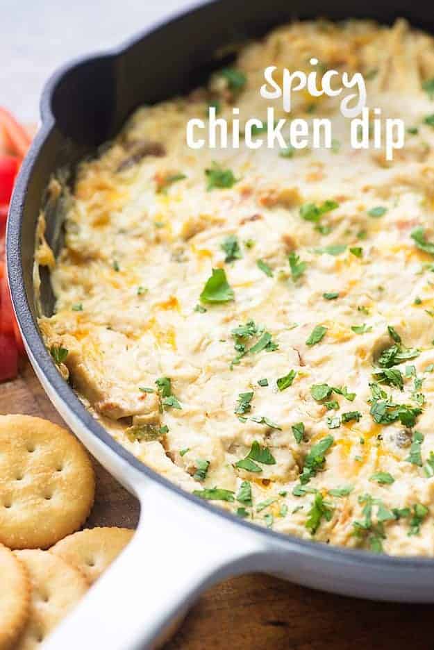 A white cast iron skillet with chicken dip in it.