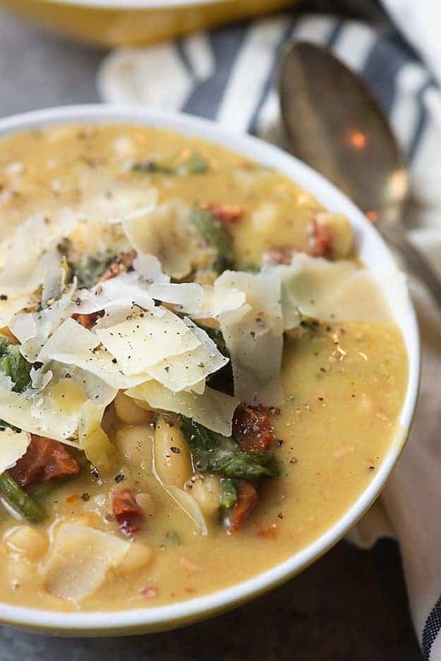 This Tuscan White Bean Soup is the perfect slow cooker soup! It's loaded with white beans, spinach, and sun-dried tomatoes. 