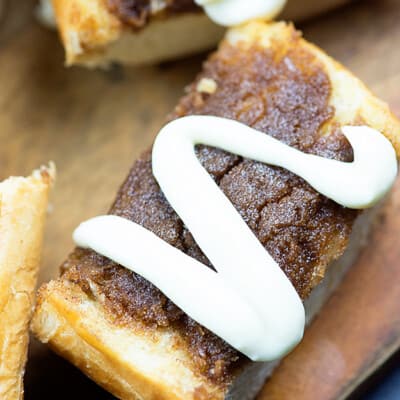 A few pieces of cinnamon roll bread on a cutting board.