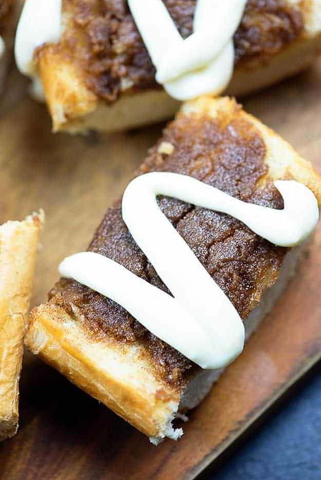 A few pieces of cinnamon roll bread on a cutting board.