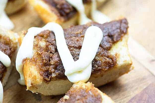 A piece of cinnamon roll bread topped with icing.