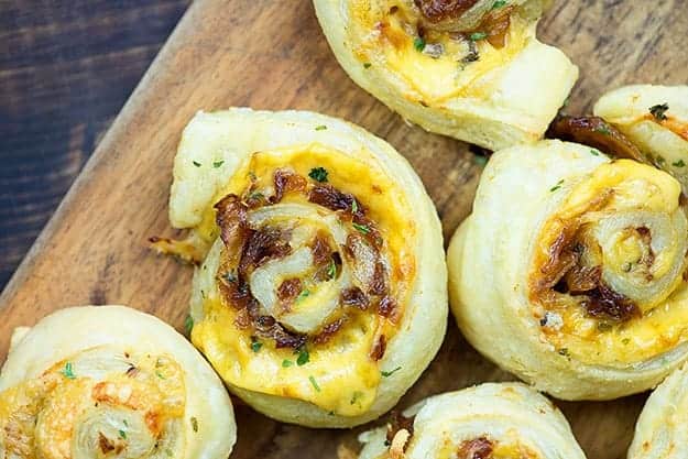 Several pinwheel pastries on a cutting board.