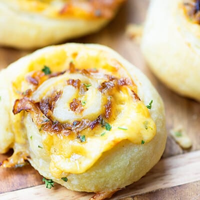 Several pinwheel pastries on a cutting board.